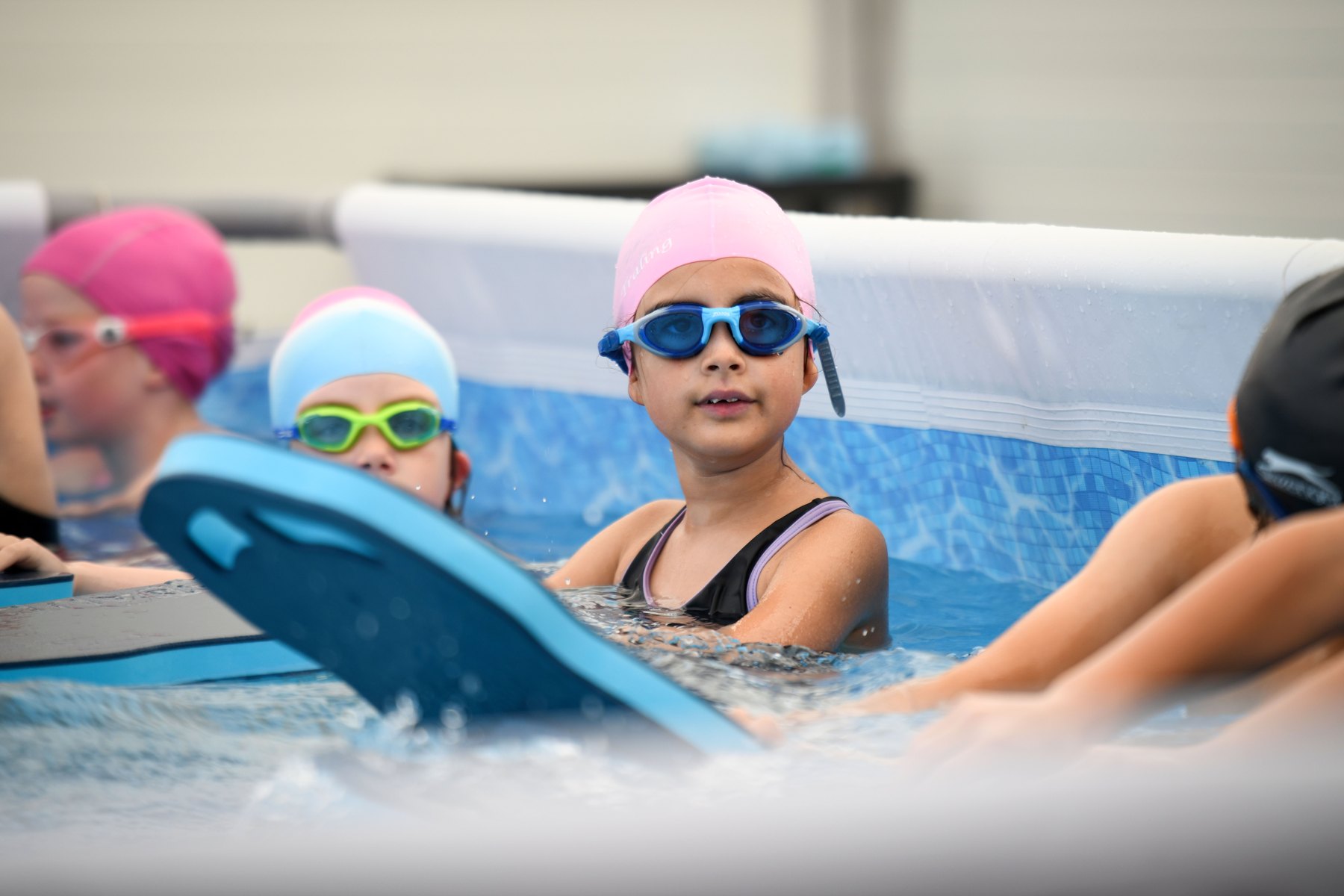 Children practising swimming with floats in a Swim:ED pool